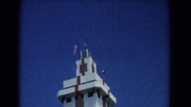 1958: A Tall Magnificent Tower with Flags Stands High in the Sky