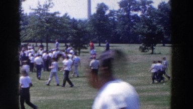 1961: People Standing in Crowd Watching Golfer Prepare for Putt