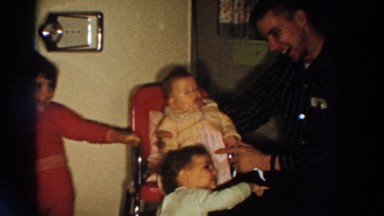 1958: Family Gathering Around Baby in Highchair, Aliquippa, Pennsylvania