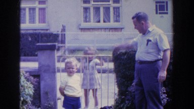 1961: A Dog at the Gate with a Family