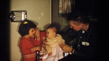 1958: A Baby Being Caressed and Cared for by Father and Sister in Aliquippa