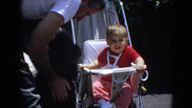 1964: Child Sitting at Children's Table Next to Black Poodle North Hollywood