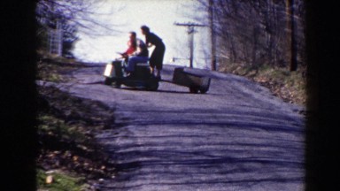 1964: Family Taking a Ride on a Lawnmower Down the Driveway, Pequot Lakes