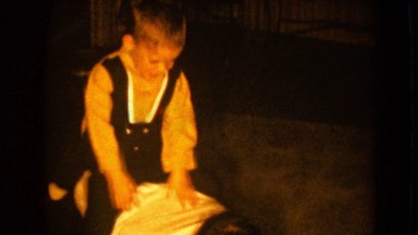 1964: Boy Playing Horse and Rider on Father's Back in Pequot Lakes, Minnesota