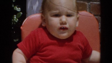 1964: Unhappy Baby in High Chair Soothed by Milk Bottle