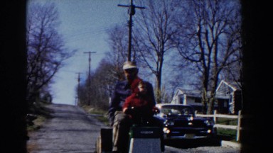 1964: Grandfather and Grandson Taking a Ride on a Lawnmower, Coming Down