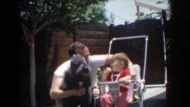 1964: teaching the baby how to behave with the family poodle. NORTH HOLLYWOOD