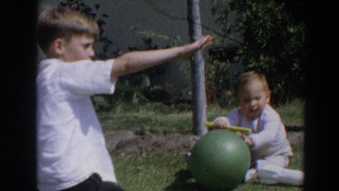1964: kids play with toys in yard. NORTH HOLLYWOOD, CALIFORNIA