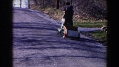 1964: A Man Riding a Village Bicycle Carrying Luggage in Pequot Lakes, Minnesota