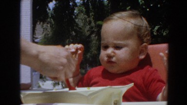 1964: Little Boy Eating Food in Highchair, North Hollywood, California