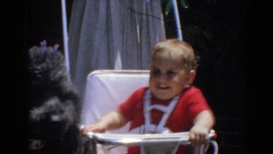 1964: Excited Baby Trying to Get Attention of Black Poodle in North Hollywood