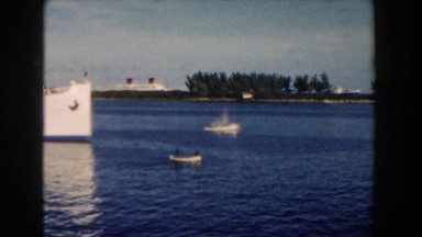 1960: A Large Boat Moving Near Small Boats in a Body of Water Miami Florida