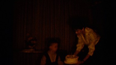 1964: a mother walking with a child carrying a cake with candles PEQUOT LAKES