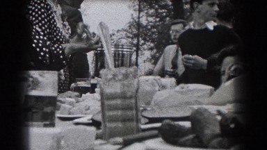 1938: Party of Adults Gathered Around Dining Table Outside