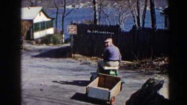 1964: grandfather and grandson taking a casual ride on the riding lawnmower.