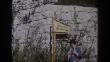 1960: Woman Standing Outside Stonewall in Israel