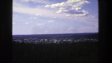 1975: airplane view of a lake and distant city. DENMARK