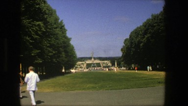 1975: Men and Women Walk Through a Garden Toward a Monument in Stockholm