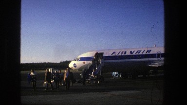 1975: Passengers Disembarking from Airplane at Stockholm Terminal