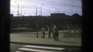 1975: a group of people standing on a brick sidewalk STOCKHOLM
