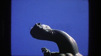 1975: woman sitting on a strange statue. STOCKHOLM