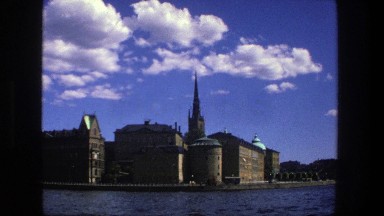 1975: The Steeple of a Church High Above the Sky on the Shore of a Lake