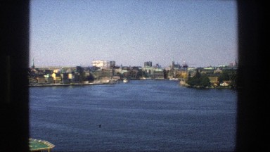 1975: White Boat Passing Along Stockholm Coast on a Clear Blue Day