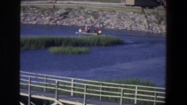 1971: People Taking a Ride in a Small Boat on a Lake in Saint Paul