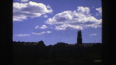 1975: Sailing Down a River Lined with Trees and Buildings in Stockholm