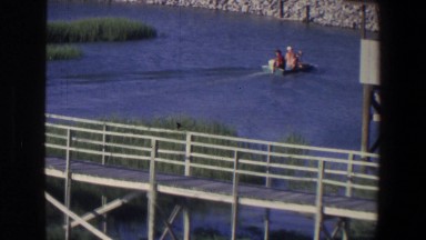 1971: A Bridge Over a River with Canoes and Boats in Saint Paul Minnesota