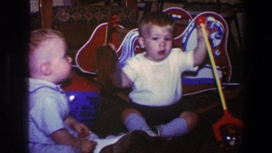 1973: Two Babies Sitting and Playing with Toys in Living Room