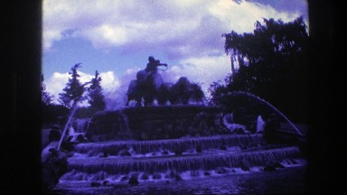 1975: A Large Water Fountain with Statue of a Man Riding an Animal on Top