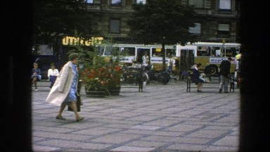1975: older woman taking a walk through town square COPENHAGEN
