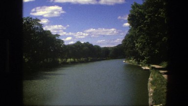 1975: floating down a body of water with shores beside