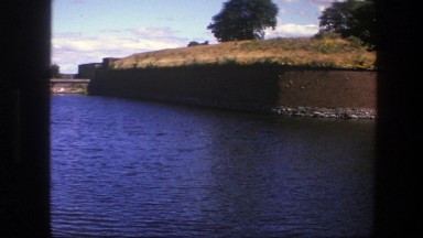 1975: large building overlooking a large river and bridge COPENHAGEN