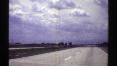 1969: a straight long highway runs through a beautiful village NEBRASKA