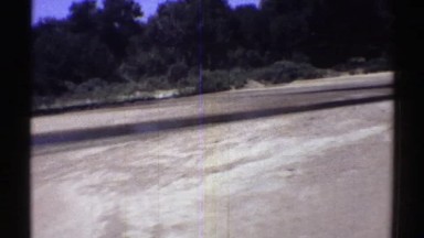 1969: view of abandoned land with trees in the background. NEBRASKA
