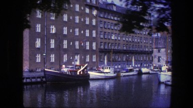1975: the canal of the city with many boats anchored and moving COPENHAGEN