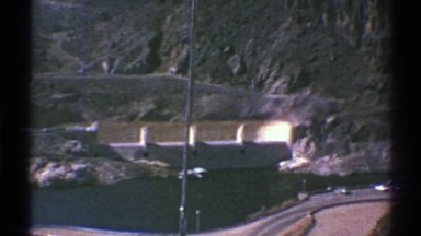 1969: a canyon full of water with a large dam between mountain ridges ARIZONA
