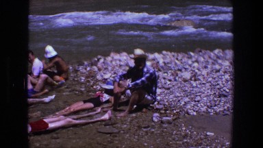 1969: a group of picnic party enjoying the freshness of water in the river UTAH