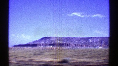 1969: a view of a large mountain ridge as seem from a moving vehicle ARIZONA