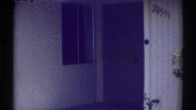 1969: lonely view of a single, hotel door. WOODLAND HILLS CALIFORNIA