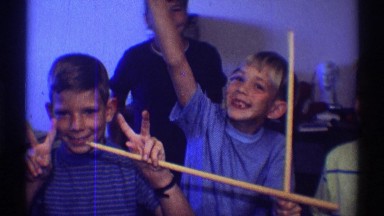 1969: three boys posing in a video with their hands out