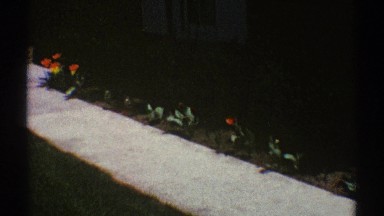 1969: view of a sidewalk leading to a home; zooming in