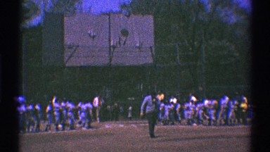 1969: a man walking onto the baseball field with a ball in his hand CLARENDON