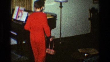 1969: child walking around a piano CLARENDON HILLS ILLINOIS