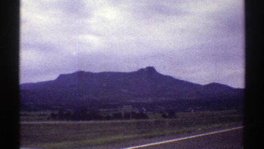 1969: a mountain next to the road with green grass COLORADO