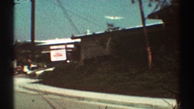 1969: a view of a car parked on a neighborhood street in a residential area
