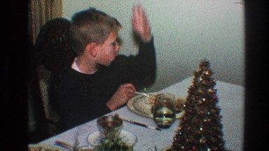 1968: little boy acting silly at the dinner table while his mom isn't catching