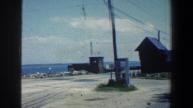 1961: view of the sea, a telephone box, a couple in the mustang resting by